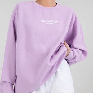 “Compassion is cool” sweater The Mayfair Group